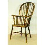 A 19th century Windsor armchair with solid elm saddle seat, pierced splat,