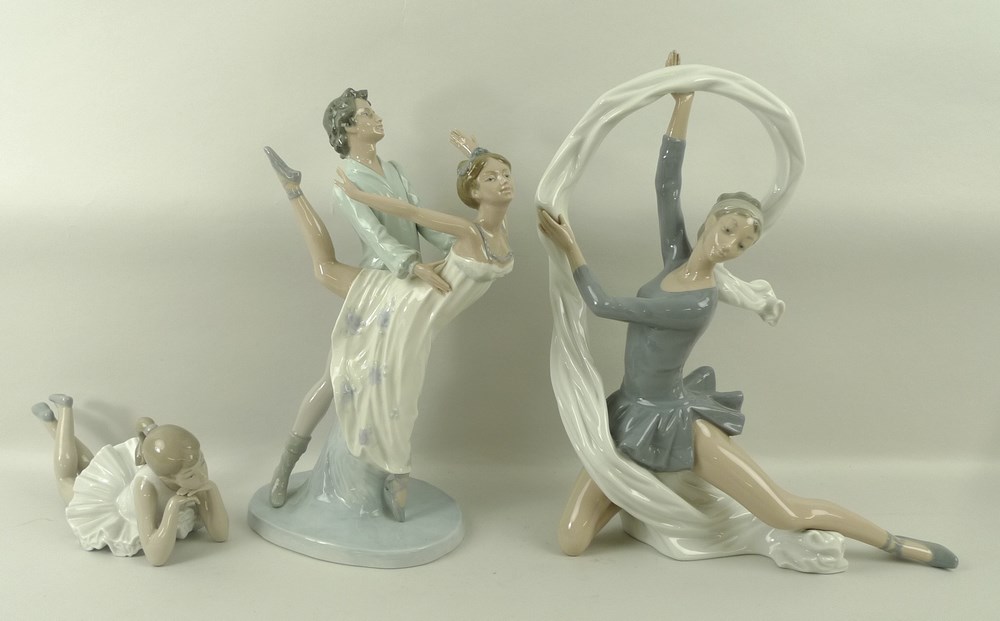 A group of Nao figurines depicting ballet dancers, comprising a girl lying down, 23 by 9cm,