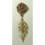 A 15ct gold and seed pearl pendant, formed as a floral corsage of three flowers amongst leaves, 5.