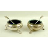 A pair of Victorian silver cauldron salts, gilt interior, with blue glass liners,