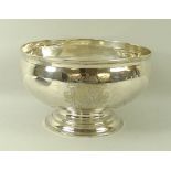 A Victorian silver bowl, of footed bellied circular form, armorial engraved, London 1865,