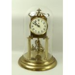 A Badishe Uhrenfabric anniversary brass torsion clock, white face with Arabic numerals,