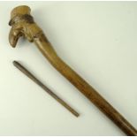 A folk art pipe walking stick, with screw top to the carved pipe bowl with a push in stem, 95cm.