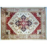 A Heriz rug with beige ground, central lobed medallion, floral field, red and cream corners,