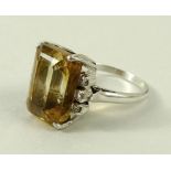 A 14ct gold dress ring, with central emerald cut amber coloured stone, 16 by 10mm,