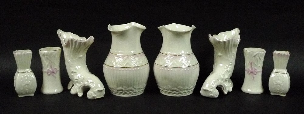 A collection of Belleek ceramics comprising a pair of pink and gilt colonial blush vases, 15cm,