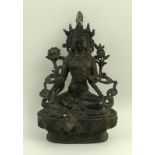 A South East Asian bronze figure of a seated Bodhisattva on a lotus flower, 14.5cm high.