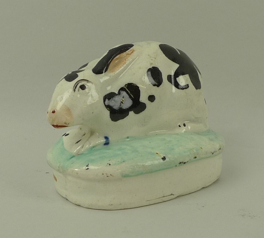 A Staffordshire model of a rabbit, 19th century, on oval base, hand painted black and white, - Image 2 of 4