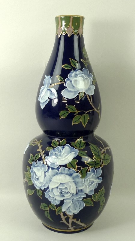 A Frederick Rhead Wood & Sons pate sur pate double gourd vase, early 20th century, with navy ground,