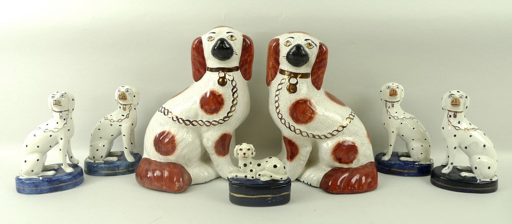 A group of four similar Staffordshire figures of seated Dalmations, 14cm,