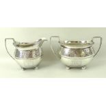 A late George III silver milk jug, with gadrooned rim and engraved vine frieze,