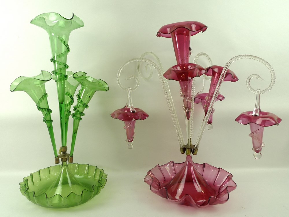 A green glass epergne, the central flute with applied twist detail,