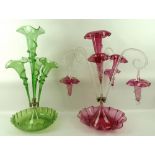 A green glass epergne, the central flute with applied twist detail,