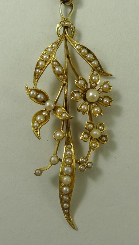 A 15ct gold and seed pearl pendant, formed as a floral corsage of three flowers amongst leaves, 5. - Image 2 of 4