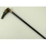 A smoking walking stick, the handle carved as a Saluki head with a single glass eye,