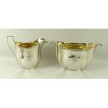 A George III silver milk jug and sugar bowl, of tapered serpentine form with reeded borders,