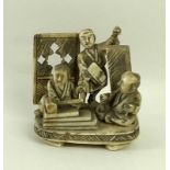 A Japanese carved ivory figural group, late 19th century, depicting three men at work,