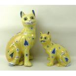 An Emile Galle yellow faience model of a seated cat, late 19th century,