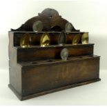 An oak spoon rack, circa 1750, the three tiers each with five holes,