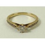 A 9ct gold and diamond ring, the central stone of approximately 0.