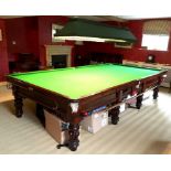 A full sized billiards table in the William IV style, on mahogany lobed baluster legs,