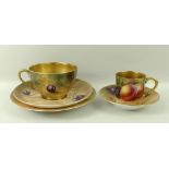 A Royal Worcester trio, comprising tea cup, saucer and plate, decorated with plums and cherries,