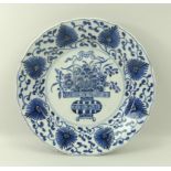 A Chinese porcelain blue and white dish, possibly Kangxi period, with lappet moulded rim,