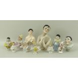 A collection of ten porcelain half doll pin cushions, 19th and early 20th century,