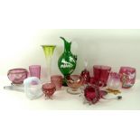 A collection of cranberry glass comprising vases, glasses, jug, bell, and cup,