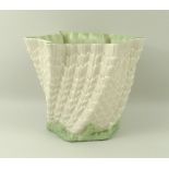 A Belleek handkerchief and shell design vase, the base and rim edged in green, 14 by 11cm.