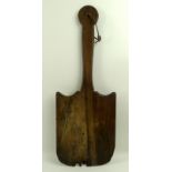 A Welsh cake peel, 18th century, the paddle and handle in cherry wood, 53cm.