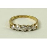 An 18ct gold and diamond ring, with five graduated totalling approximately 0.5ct, size O/P, 2.8g.