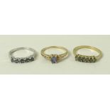 A 9ct white gold and five stone alexandrite ring, size N, a 9ct gold and six stone alexandrite ring,