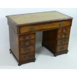 A late 19th century mahogany twin pedestal desk, with beige tooled leather skiver,