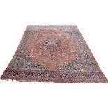 A large central Persian carpet, early 20th century, finely knotted, with red ground,