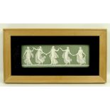 A Wedgwood rectangular plaque depicting dancing girls on an olive green ground, 8 by 23cm.