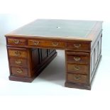 A late Victorian mahogany partners desk, dark green tooled leather skivver,