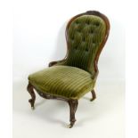 A Victorian stained walnut nursing chair, carved and moulded frame,