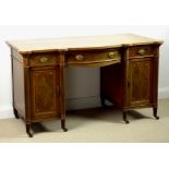 An Edwardian mahogany bow and break fronted desk, attributed to Gillows, Lancaster,