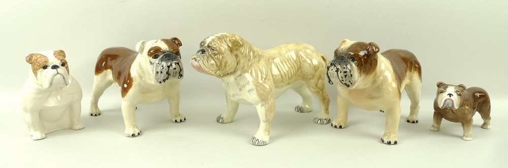 A group of bull dog figures comprising a Beswick seated bull dog,