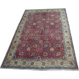 A Tabriz rug, red ground wool on cotton all over flower-head vine and leaf pattern,