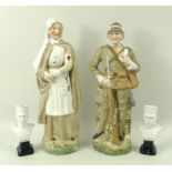 A pair of bisque figurines depicting a wounded Boer War soldier, and a nurse, 23cm,