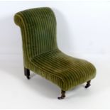 A Victorian low nursing chair, with striped green upholstered fabric,