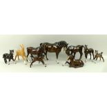A group of Beswick horses, comprising a bay mare and foal, three further bay foals,