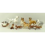 A collection of ceramic animal figurines comprising Beswick figures of three standing foxes,