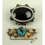 A Victorian agate tiger's eye brooch set with eight cabochons surrounding the central stone,