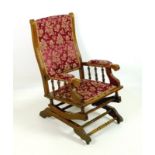 A Victorian mahogany rocking chair, spindle supported arms,