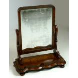 A mid Victorian swing mirror, flame mahogany veneer, serpentine base and a mercury plate,