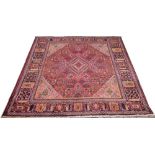 A Mimeh rug, with red ground and geometric diamond decoration, 345 by 242cm.