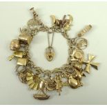 A 9ct gold charm bracelet, with twenty-five charms, some plated, 55.3g.